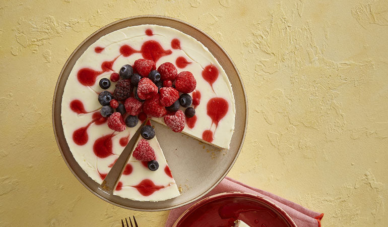 Raspberry Ripple Cheesecake with a slice cut out