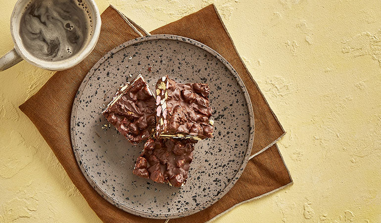 Nadiya Hussain's Rocky Road on a plate with coffee