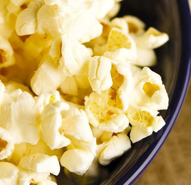 Close up shot of sweet popcorn in a blue bowl.